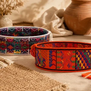 Hand-embroidered ceremonial belt with colorful geometric patterns and braided fastening cords